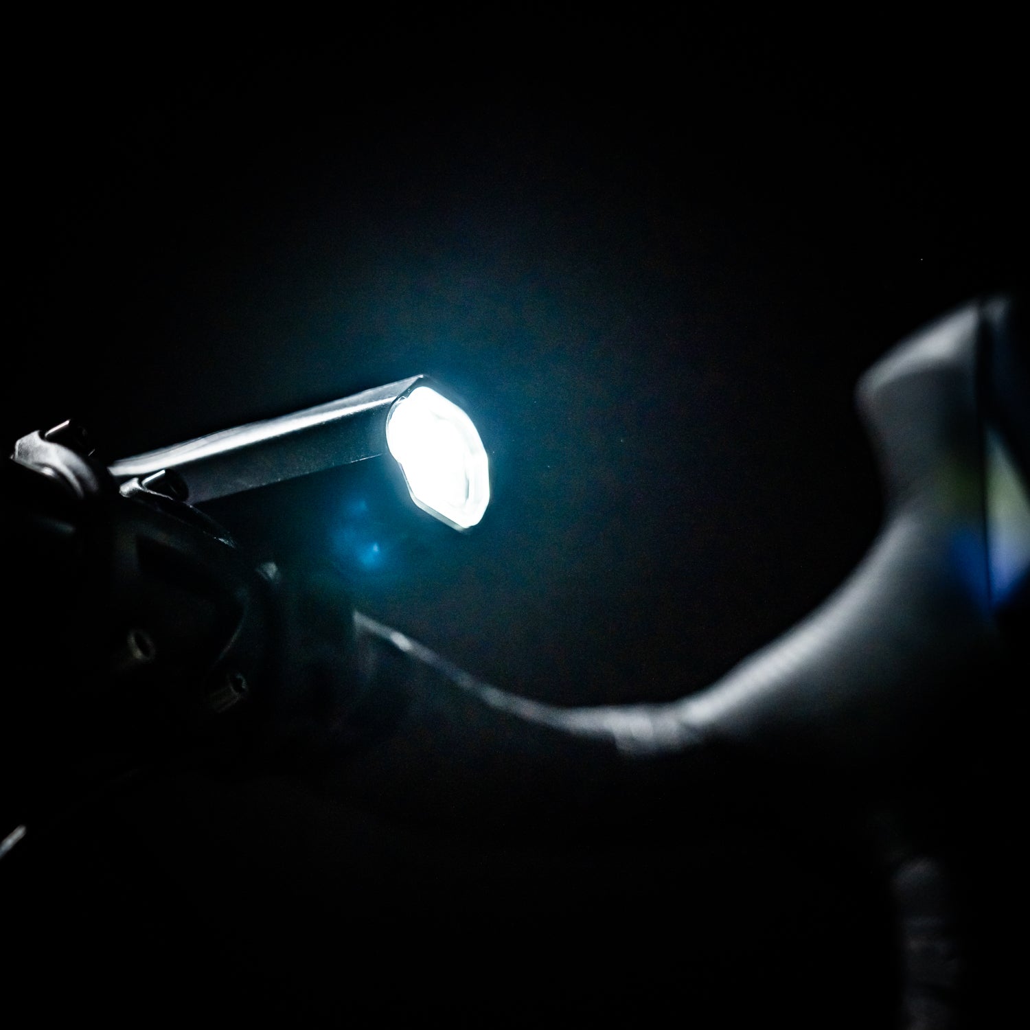 Lezyne KTV Drive Pro 300+ LED front bike light mounted on gravel bike, turned on, emitting a powerful light beam for enhanced cycling safety.