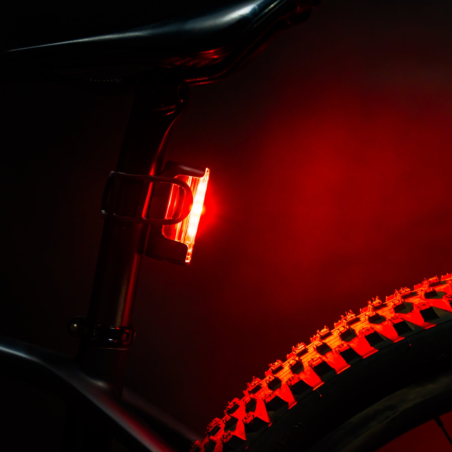 STRIP DRIVE 300+ REAR LED bike light mounted on a gravel bike seat post, emitting a super bright red light for high visibility standards.