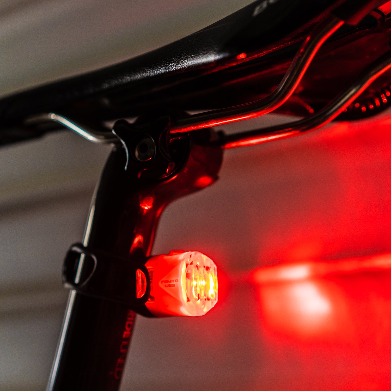 FEMTO USB-C LED rear bike light mounted on seatpost, bright red beam, high visibility for road & commuter cyclists.