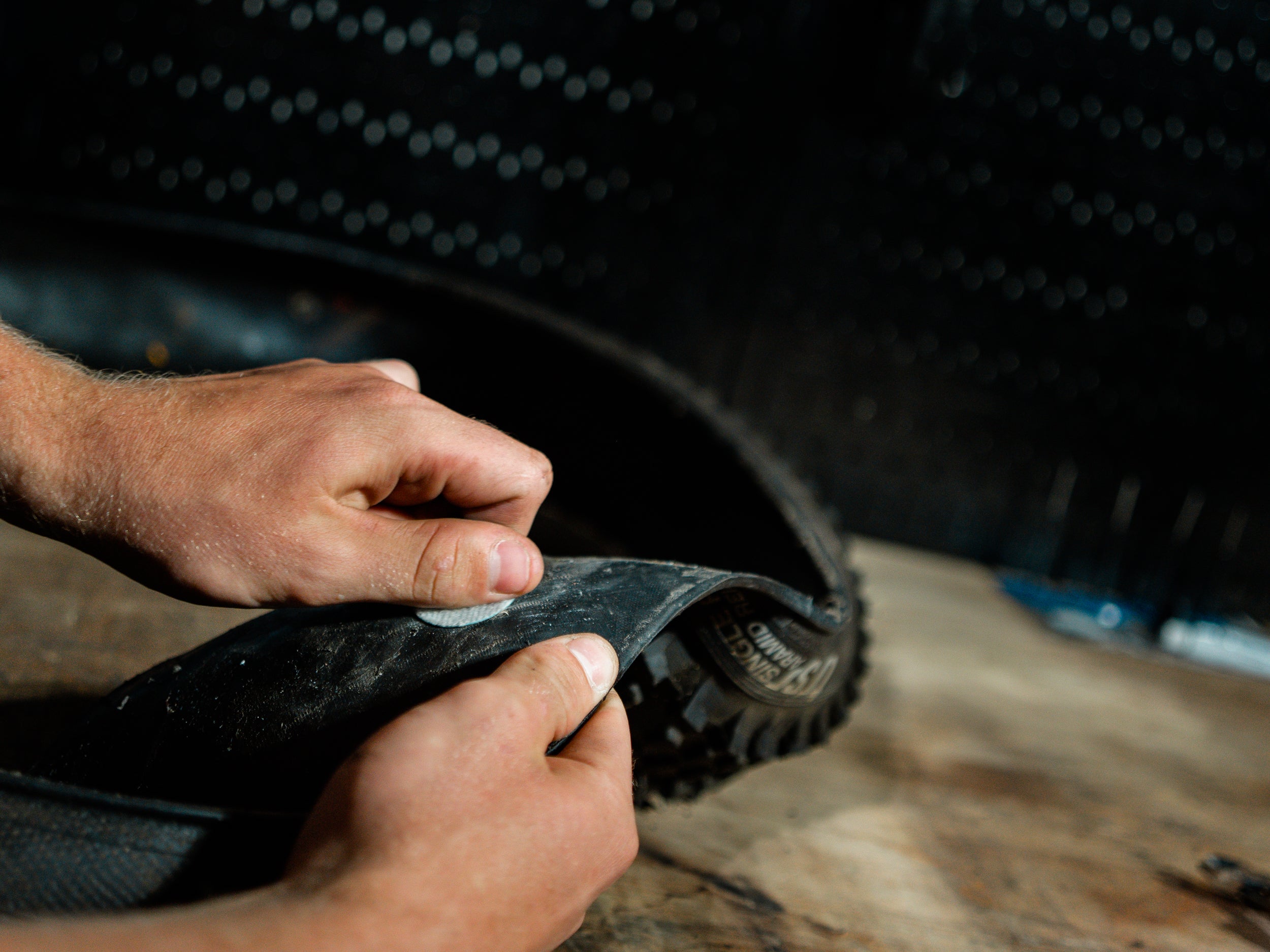A tubeless-ready tire being sealed with a high-quality tubeless pro plug for durability.