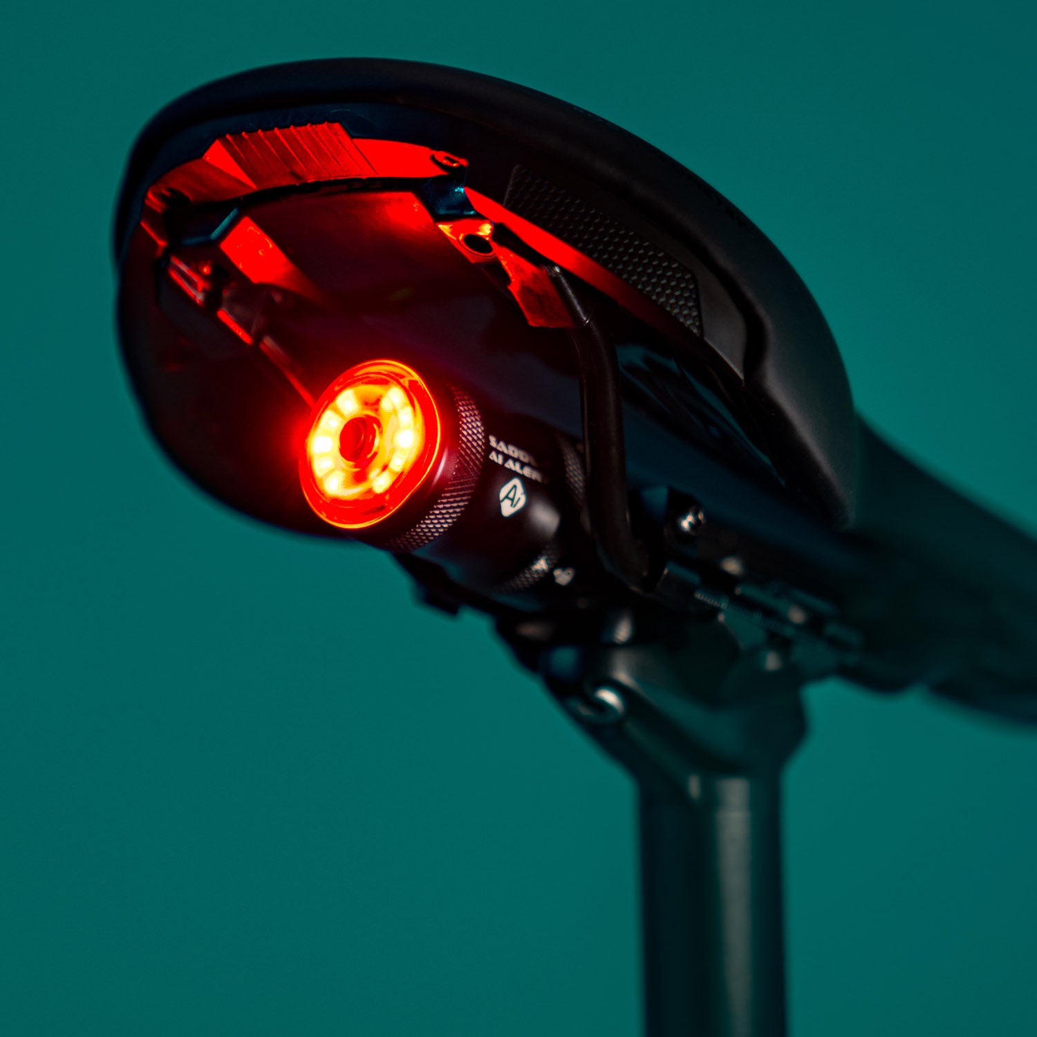 SADDLE Ai ALERT 250 REAR bike light mounted on gravel bike seat rail, emitting a powerful red brake light for safety.