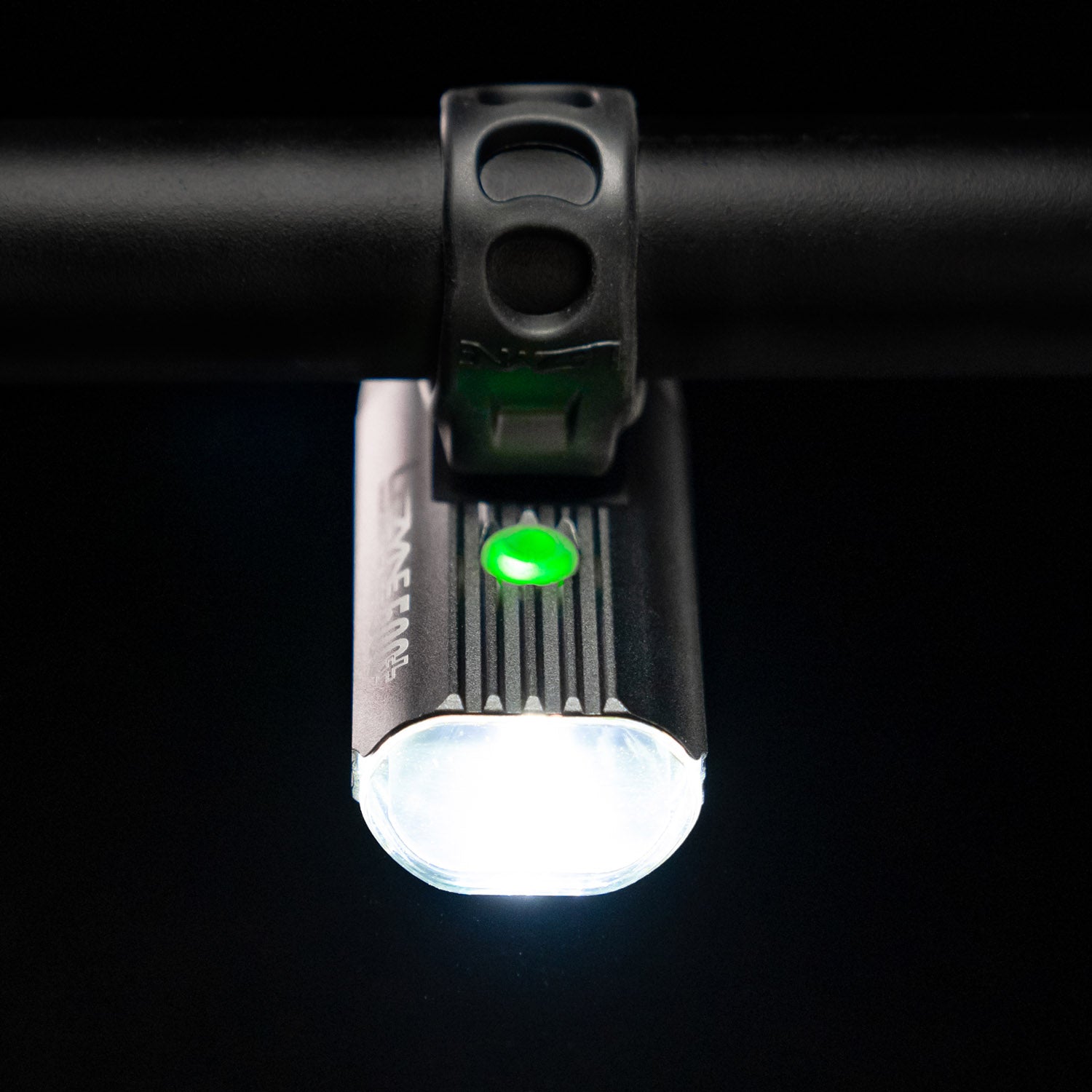 Bird's-eye view of the Lezyne Macro StVZO 500+ Reverse headlight, mounted upside down on the handlebars, with a small green circular power light on top.