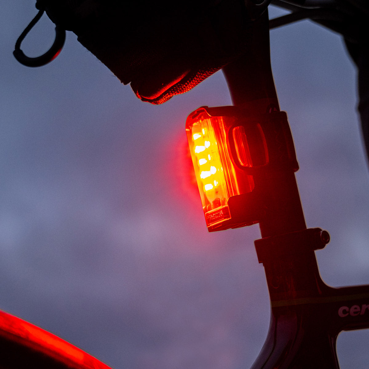 STRIP DRIVE 300+ LED rear bike light on gravel bike seatpost, bright red beam, high visibility, USB-C rechargeable.