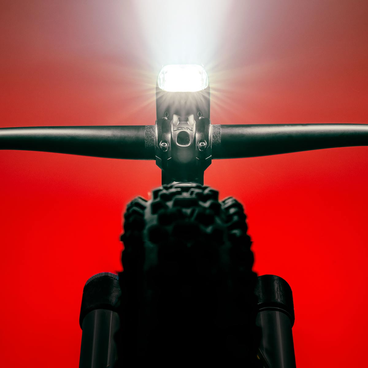 Mega Drive 2400+ LED front bike light mounted on a mountain bike handlebar.