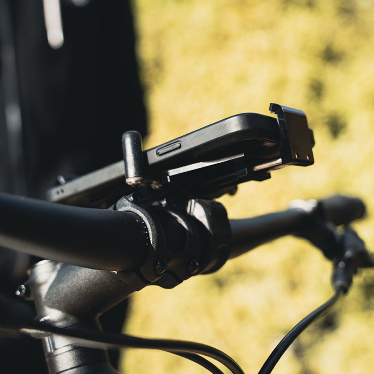 CNC Phone Mount on a road bike, demonstrating compact size and precision fit for modern smartphones.