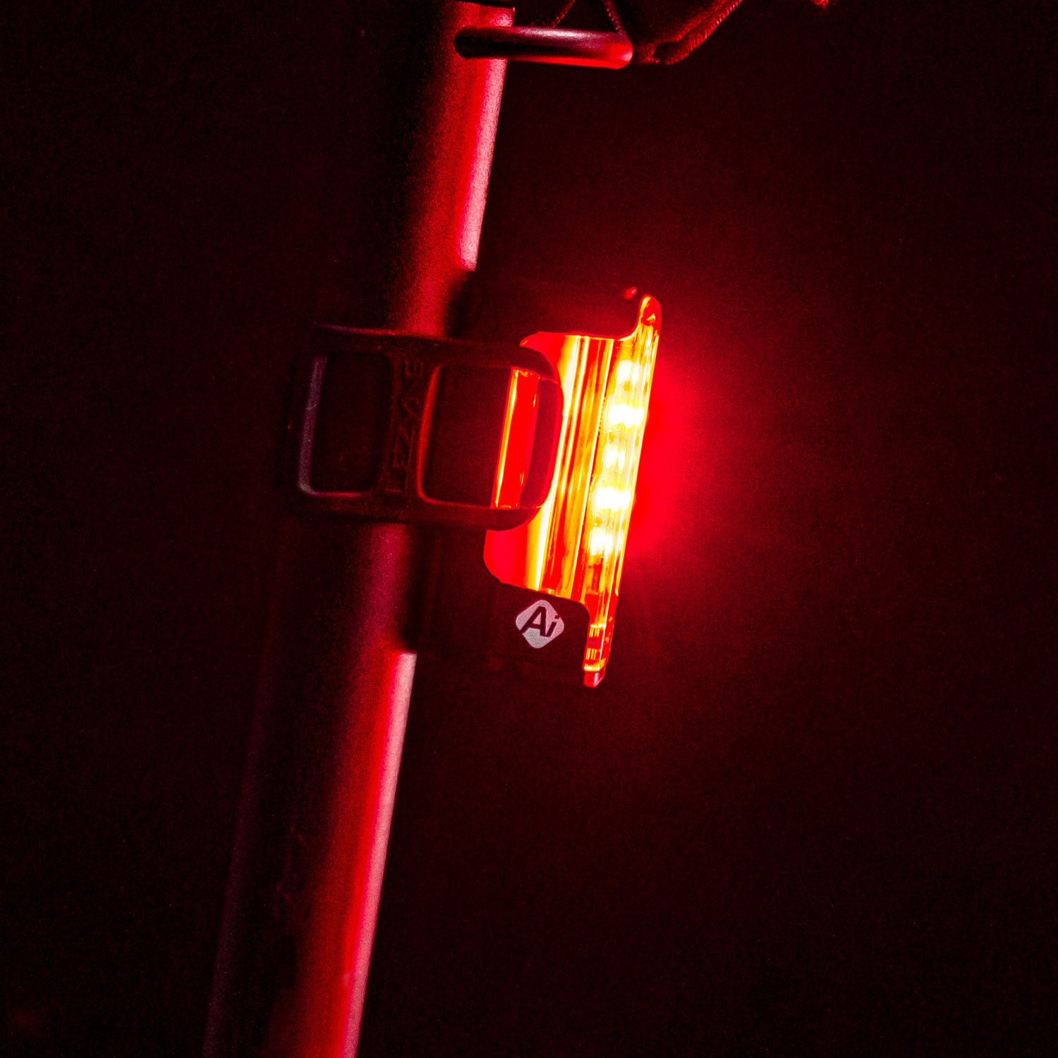 Side view of Lezyne Strip Pro Ai Alert 400+ smart LED rear bike light mounted on seat stem for enhanced safety.