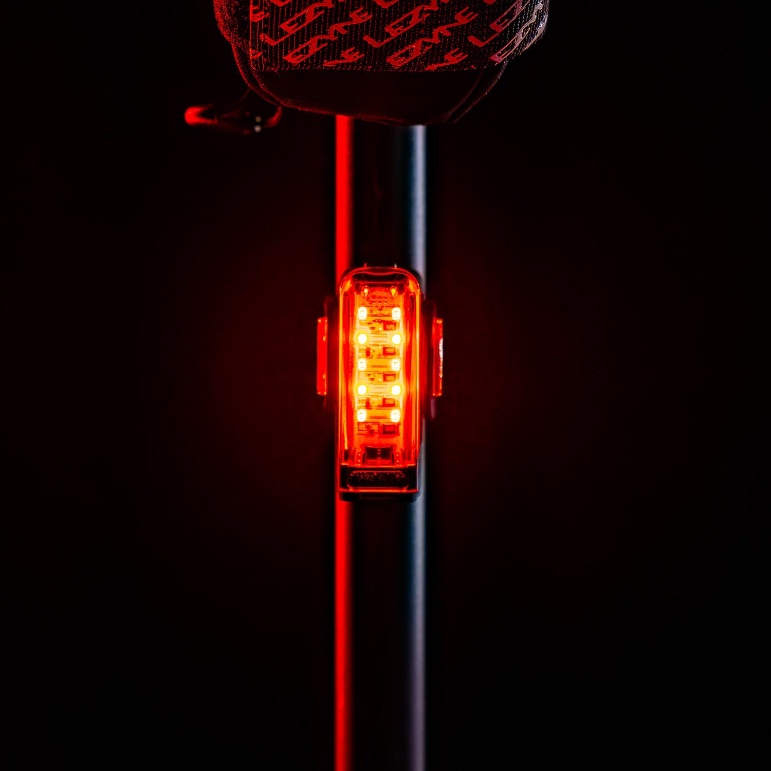 Straight-on view of Lezyne Strip Pro Ai Alert 400+ smart LED rear bike light mounted on road bike seat stem for maximum visibility.
