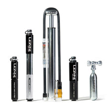 Tire inflation accessories for a bicycle. Including 3 portable pumps, 1 floor pump, and a compressed air canister with a valve for a bicycle tire.