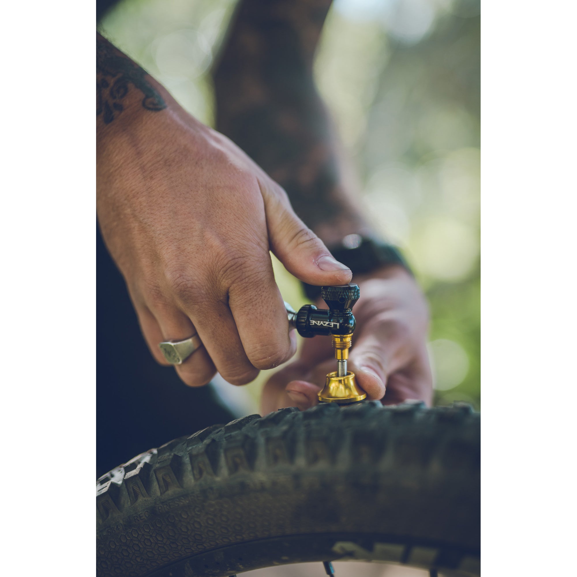 Live action shot of Lezyne CO2 Blaster inflating a tubeless bike tire with precision and speed.