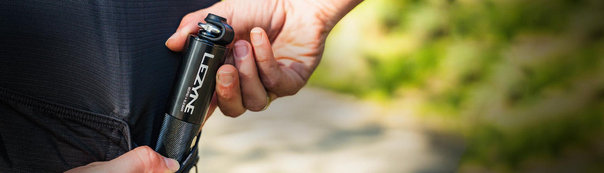 Close-up of Lezyne hand pump for mountain bikes, built for quick tire inflation on rugged and challenging mtb trails.