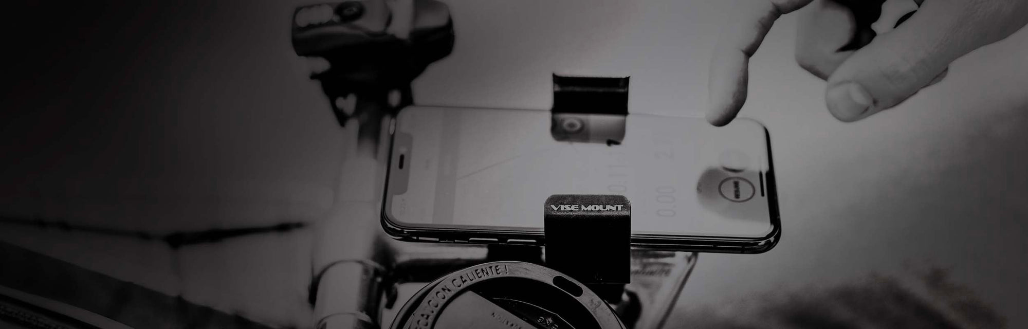 A phone mounted to bicycle handlebars.