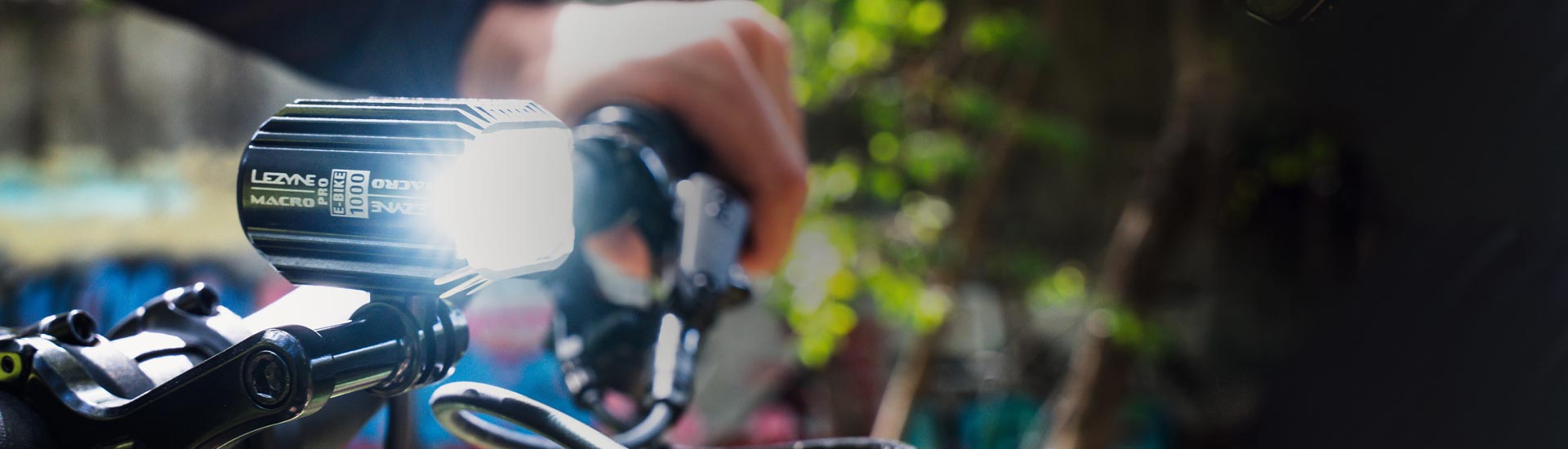 A bright light mounted on bicycle handlebars with Lezyne Classic HB STVZO E800 K 1906 printed on the side of the light.