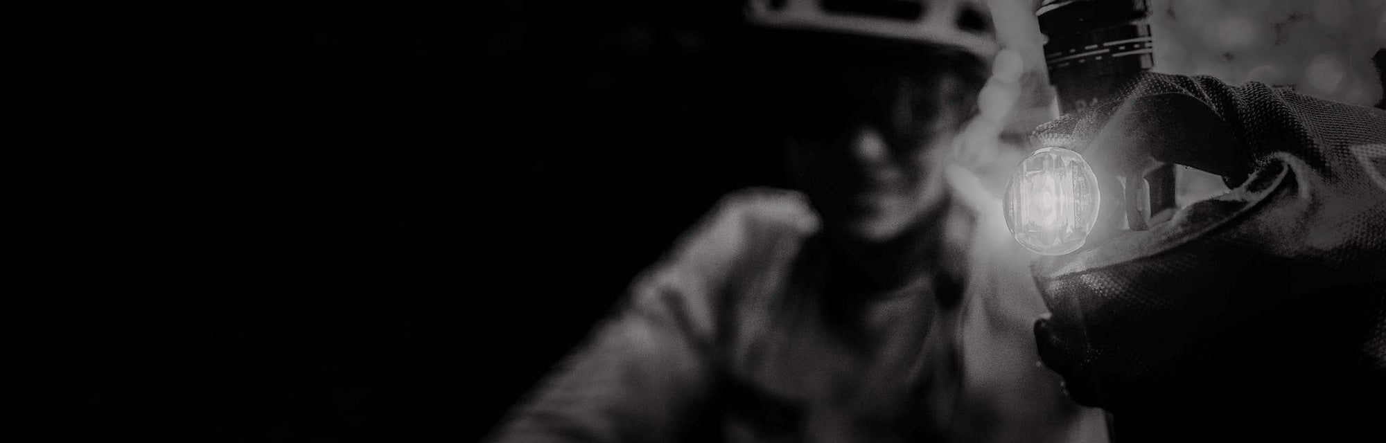 Someone holding a bright light in their gloved hand