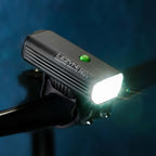 Profile view of the MACRO DRIVE 1400+ front LED bike light mounted on road bike handlebar, ideal for cycling after sunset.
