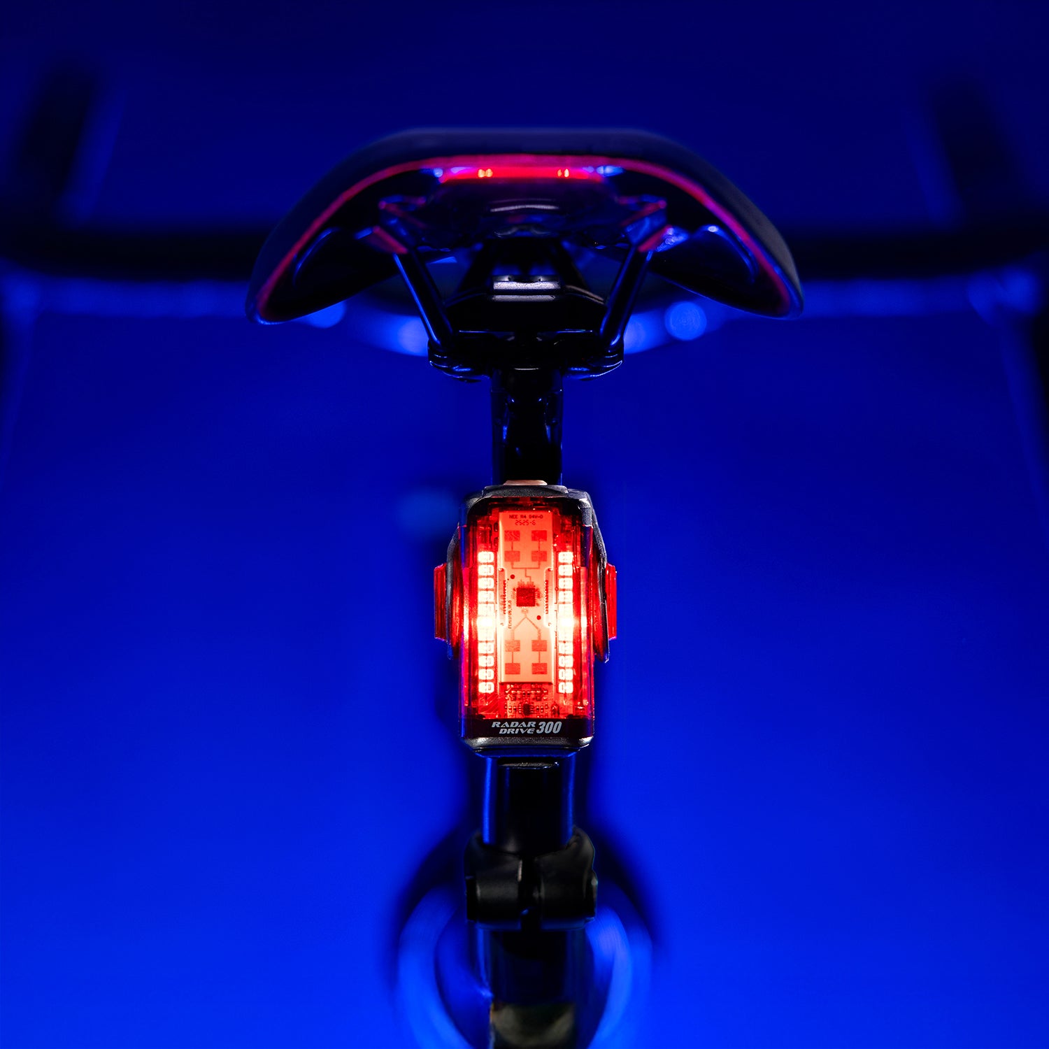 Lezyne Radar Drive LED rear bike light on road bike seatpost; lamp shining to rear, clear beam and reflective details visible.