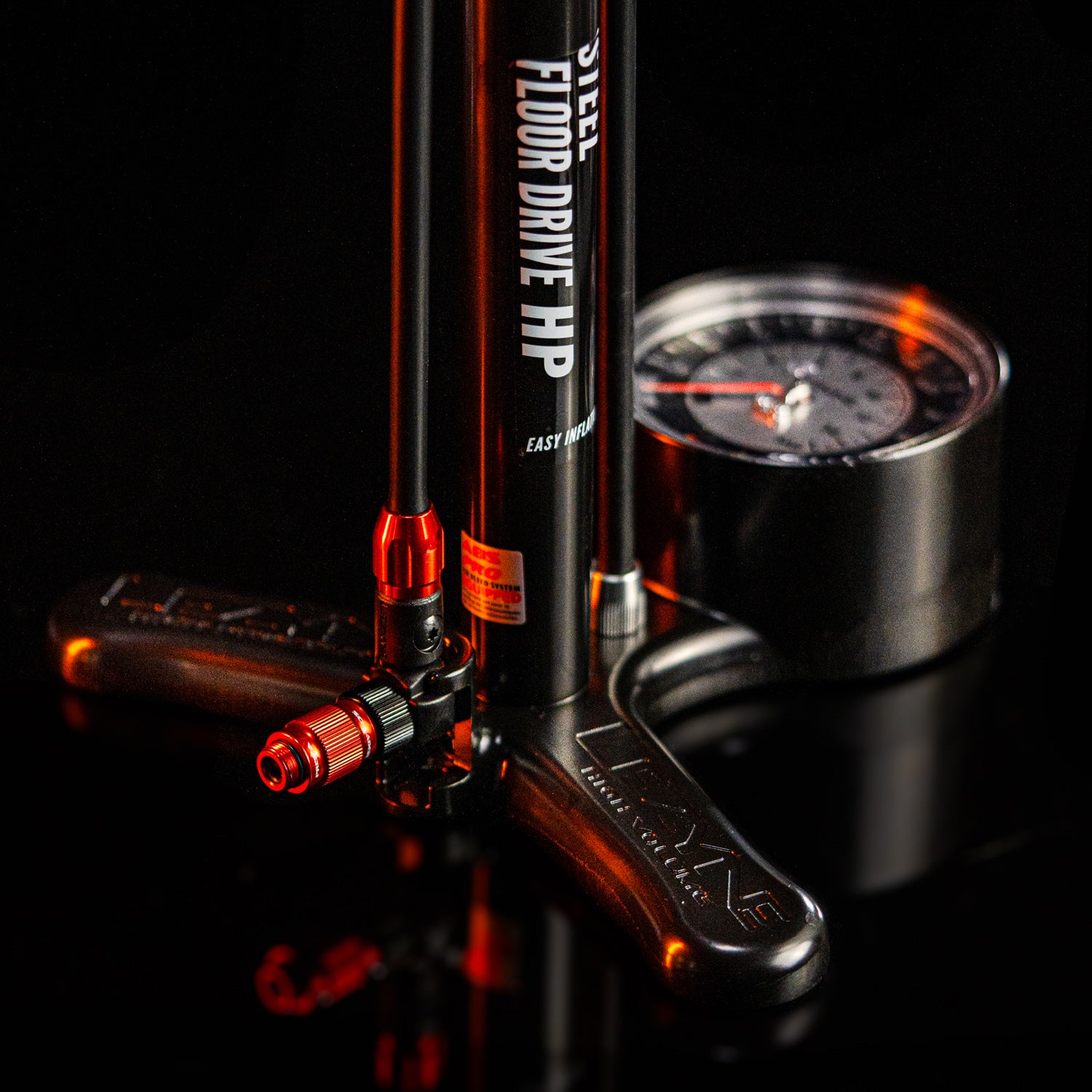 Durable Lezyne Steel Floor Drive 3.5 bike pump with wood handle, analog gauge, and extra-long hose for convenient tire inflation.