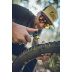 CO2 cartridge in use with Lezyne Blaster, inflating tubeless tire quickly after inserting plug into puncture.